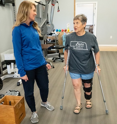 Physical Therapist working with a woman on crutches